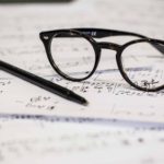 dayne topkin glasses, pen and paper